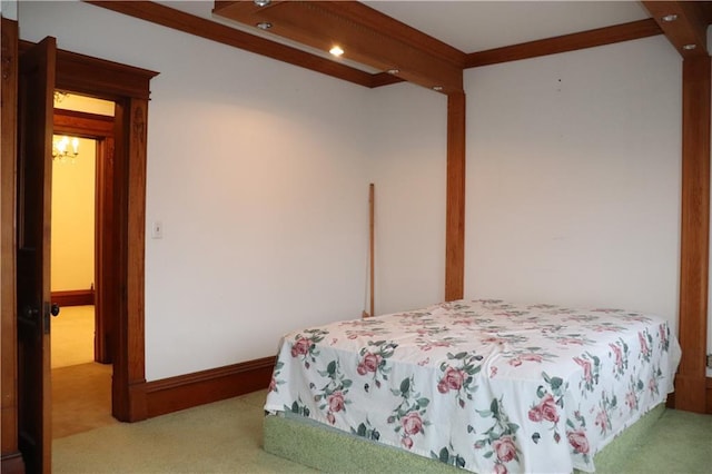 bedroom with crown molding and light carpet