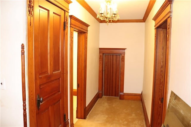 hallway with ornamental molding, light carpet, and a chandelier