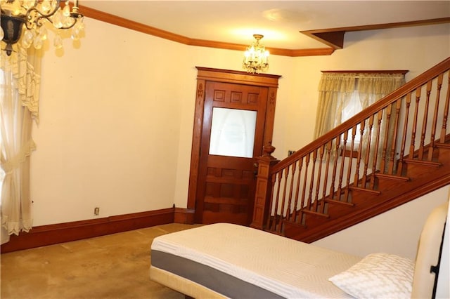 carpeted foyer entrance with ornamental molding and an inviting chandelier