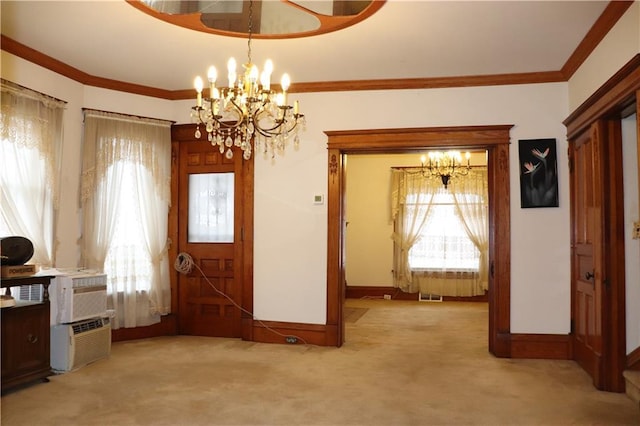 foyer with carpet flooring, ornamental molding, and an inviting chandelier