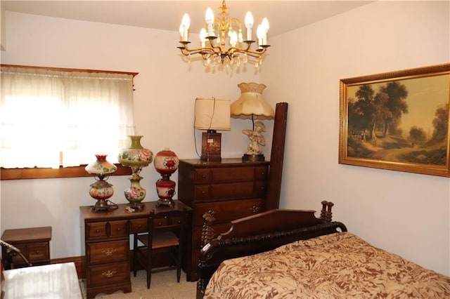 carpeted bedroom featuring an inviting chandelier