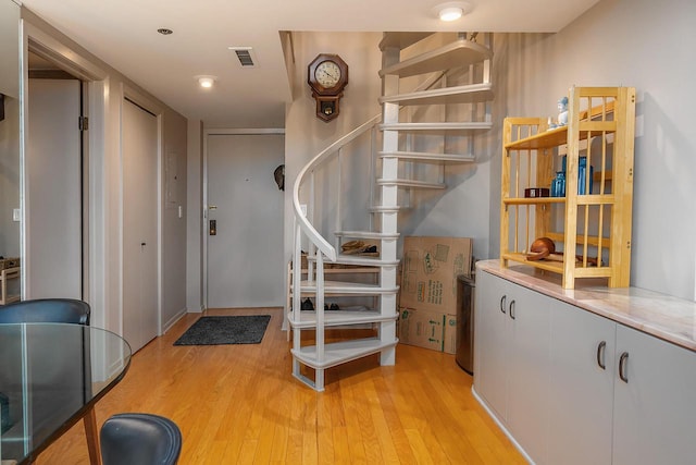 stairs featuring hardwood / wood-style floors