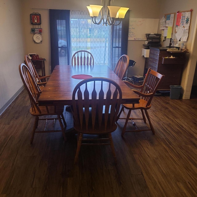 dining room with dark hardwood / wood-style floors and a notable chandelier