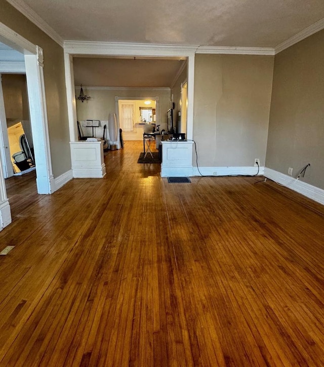 unfurnished living room featuring hardwood / wood-style flooring and ornamental molding