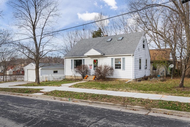 bungalow-style house featuring a garage and an outdoor structure