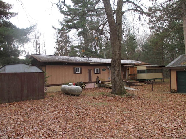 rear view of house with an outbuilding and a deck