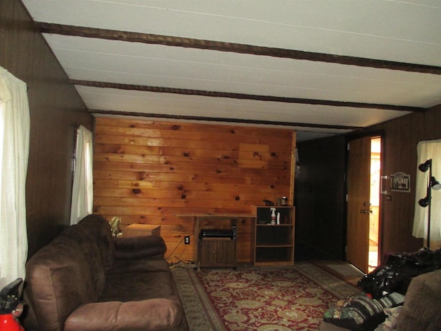 living room with beam ceiling and wooden walls