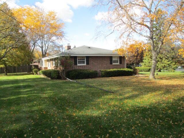 view of side of home with a yard