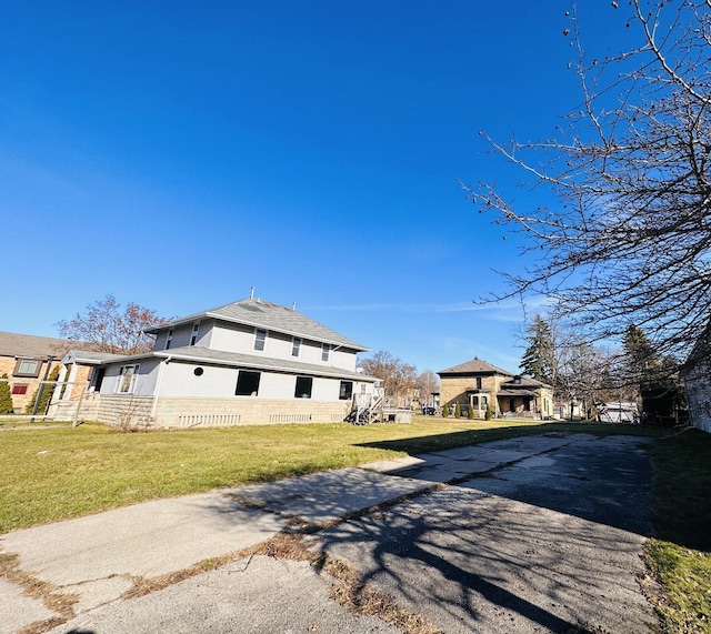 view of side of property with a lawn