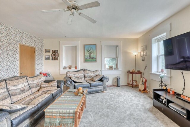 carpeted living room with ceiling fan