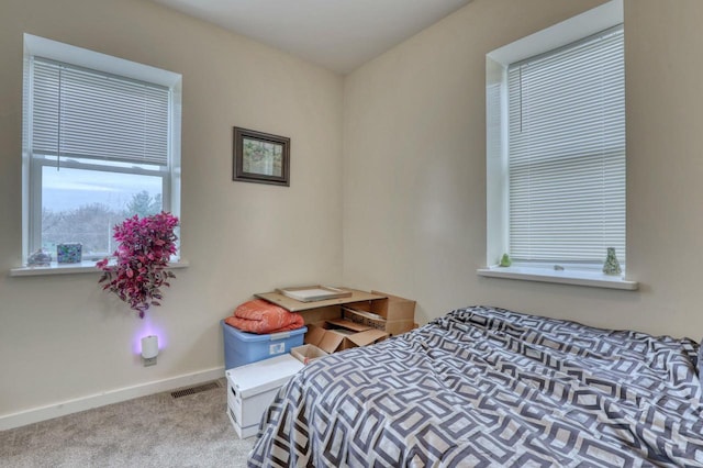 bedroom featuring light colored carpet