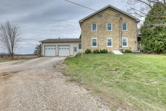 view of property featuring a front lawn and a garage