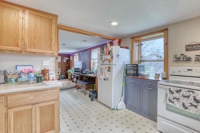 kitchen featuring light brown cabinets and white appliances