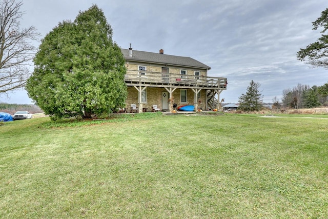 back of house with a lawn and a deck