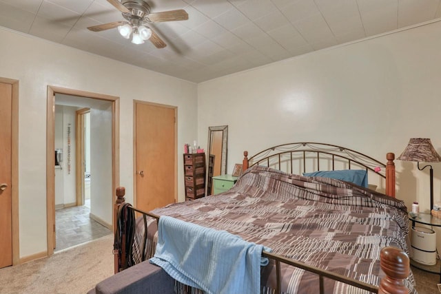 carpeted bedroom with ceiling fan and crown molding