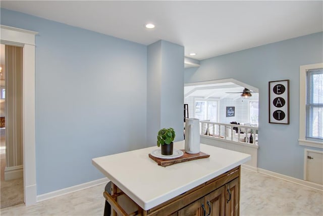 kitchen featuring ceiling fan and a center island