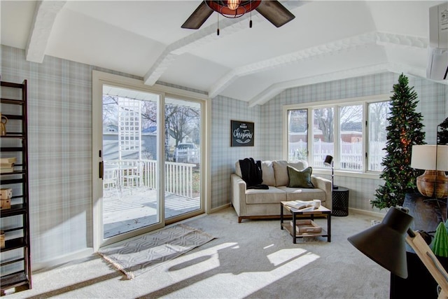 living room featuring ceiling fan, carpet, and vaulted ceiling