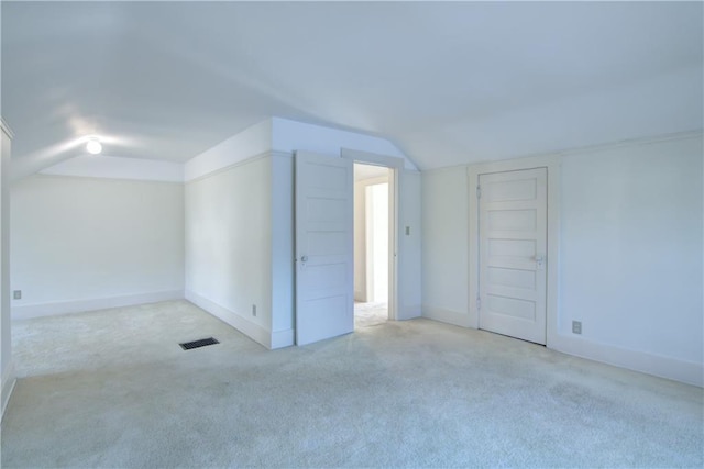 additional living space with light colored carpet and lofted ceiling