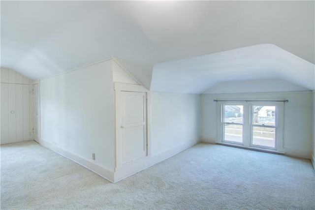 additional living space with light carpet and lofted ceiling