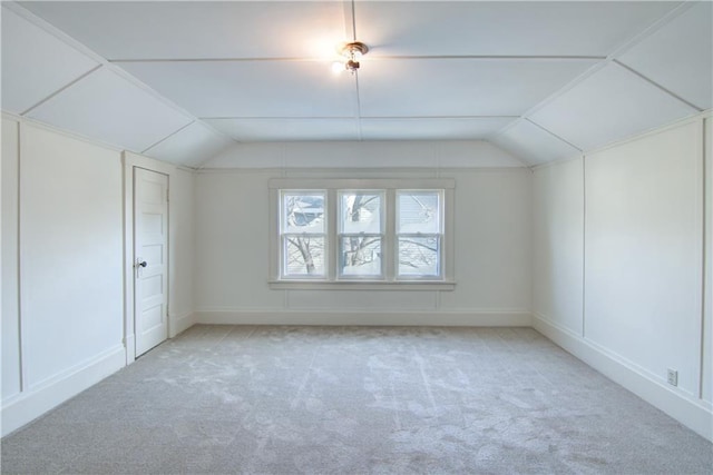 bonus room featuring light colored carpet and vaulted ceiling