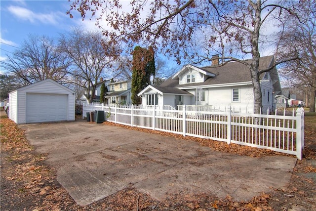 view of front of house featuring a garage and an outdoor structure