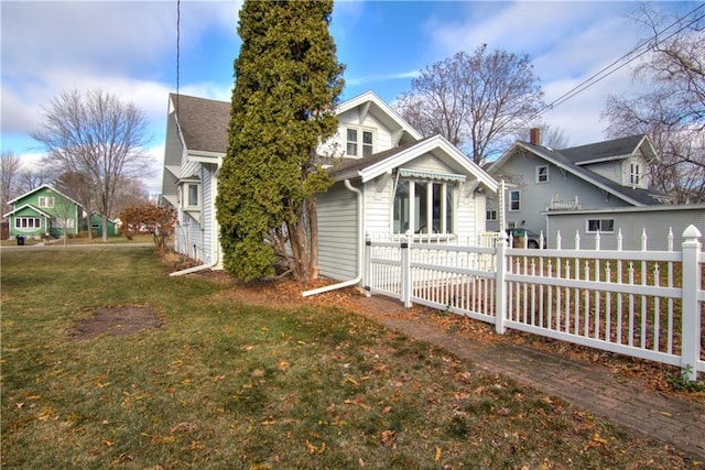 rear view of house featuring a lawn