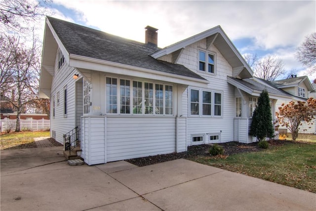 rear view of property with a lawn