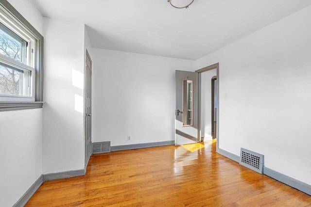 empty room with light hardwood / wood-style flooring