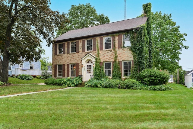 colonial-style house with a front lawn