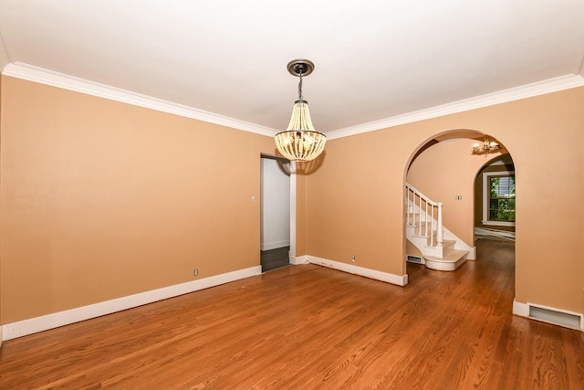 unfurnished room featuring ornamental molding and hardwood / wood-style flooring