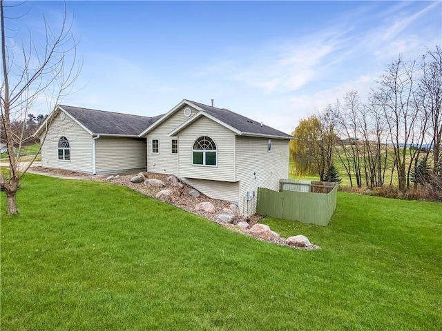 back of house with a lawn