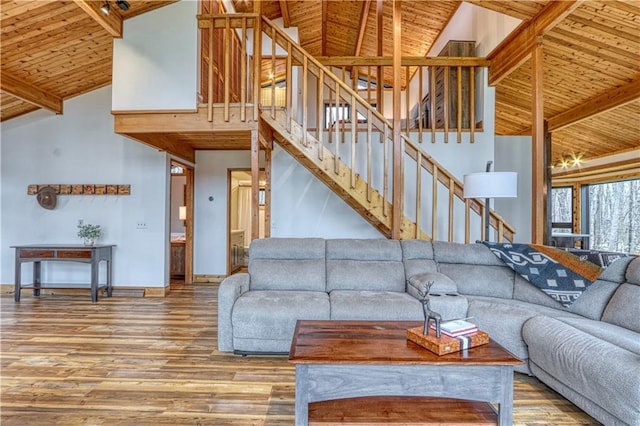 living room featuring beamed ceiling, high vaulted ceiling, wood ceiling, and hardwood / wood-style flooring