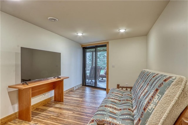 living area with hardwood / wood-style flooring