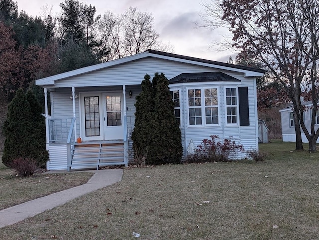 view of front of property with covered porch and a front yard