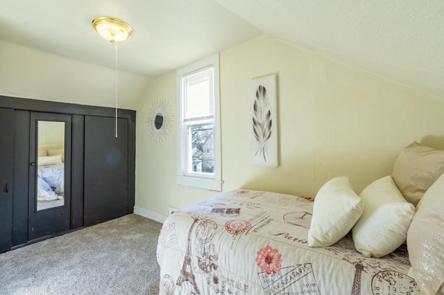 carpeted bedroom with vaulted ceiling