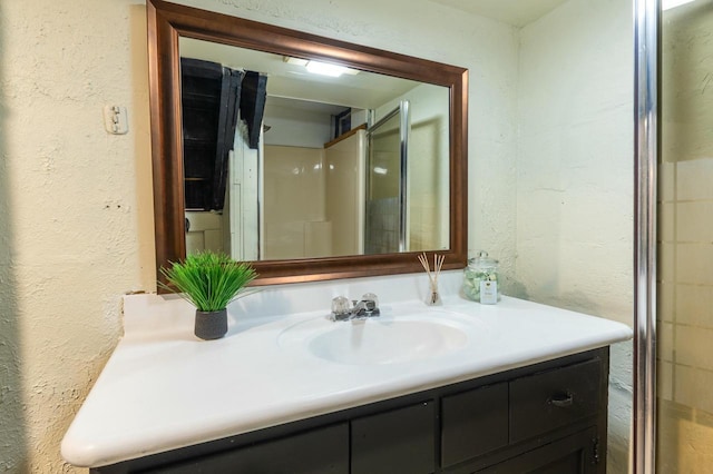 bathroom featuring vanity and a shower