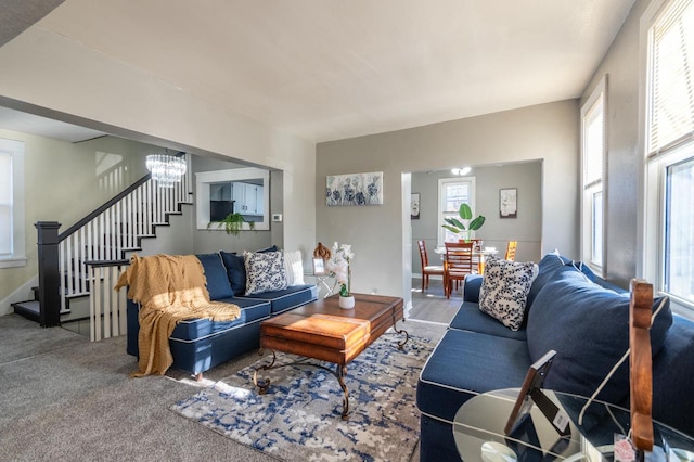 living room with carpet flooring and an inviting chandelier