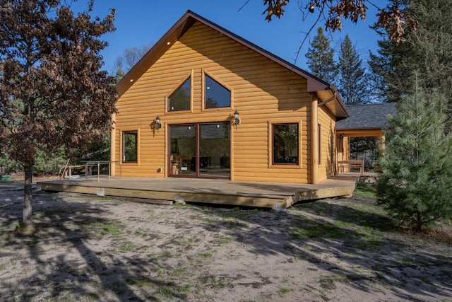 back of house featuring a wooden deck