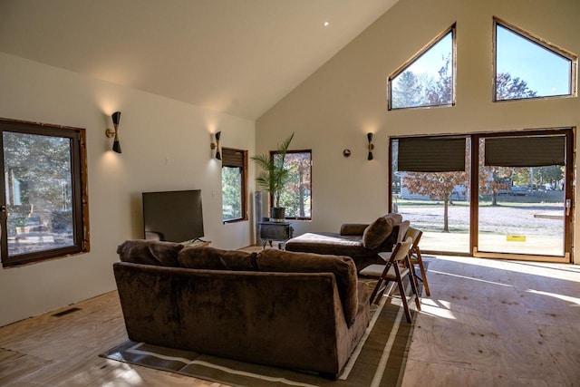 living room with high vaulted ceiling and light hardwood / wood-style flooring