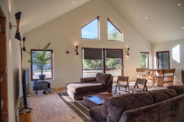 living room with high vaulted ceiling and a healthy amount of sunlight