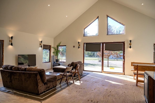 living room with light carpet and high vaulted ceiling