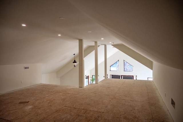 additional living space featuring lofted ceiling