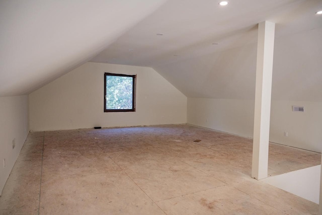 additional living space featuring vaulted ceiling