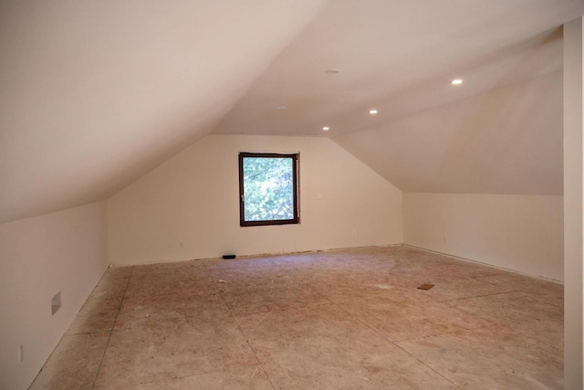 additional living space featuring lofted ceiling