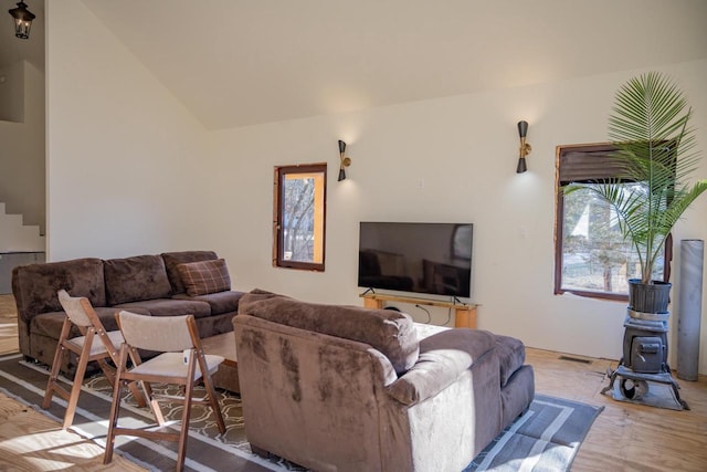 living room with light wood-type flooring and lofted ceiling