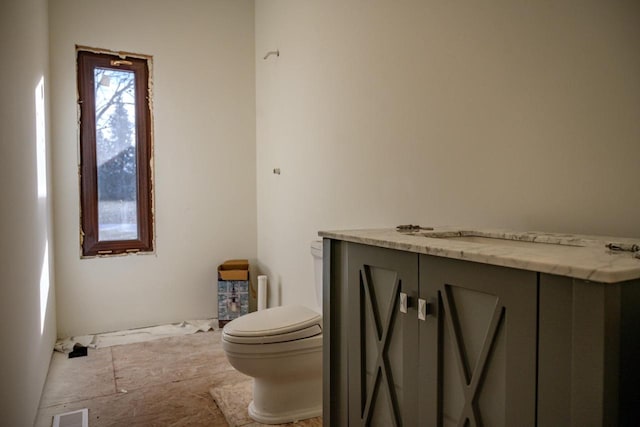 bathroom featuring vanity and toilet