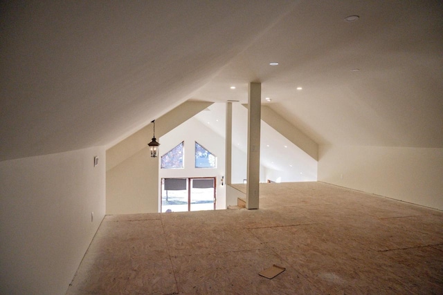 additional living space featuring lofted ceiling