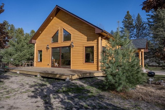 rear view of house featuring a wooden deck