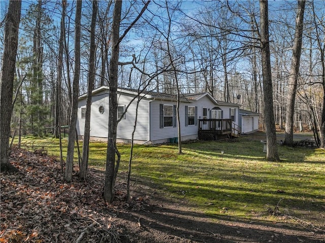 view of property exterior with a lawn, an outbuilding, and a garage