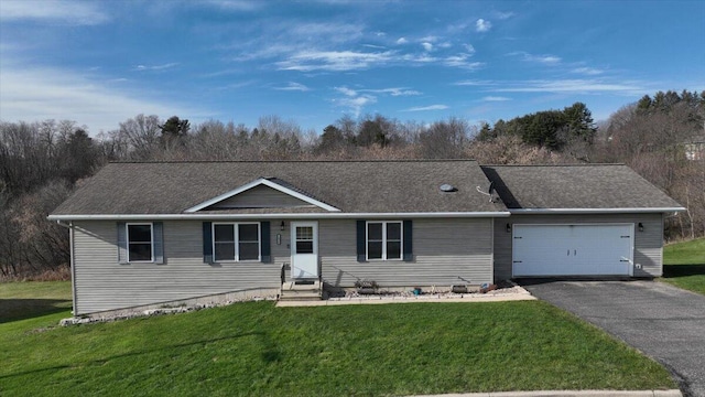 ranch-style house featuring a front yard and a garage